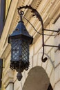 Old-fashioned street wall lamp made of black metal. Gray facade of an old house. Lviv, Ukraine Royalty Free Stock Photo