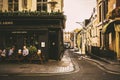 Old fashioned style London corner pub and street life. Warm sunny day in the city Royalty Free Stock Photo