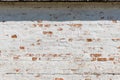 Old fashioned surface of wall with bricks and white stucco