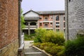 Old-fashioned tile-roofed buildings with brick facades in cloudy