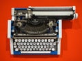 Old-fashioned typewriter on a bright orange background Royalty Free Stock Photo