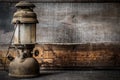 Old fashioned vintage kerosene oil lantern lamp burning with a soft glow light with aged wooden floor Royalty Free Stock Photo