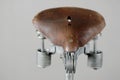 Old-fashioned vintage leather bike saddle with spring