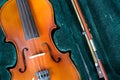 Old-fashioned violin on green velvet background. Royalty Free Stock Photo