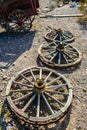 Old-fashioned wagon wheels next to a large wagon