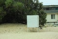 Empty beach. Old fashioned white barn. Wooden dressing room. Seaside resort. Fencing for dressing.