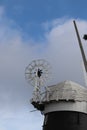 Windmill house, sails spinning in the blue sky