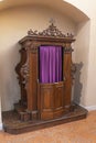 Old-fashioned wooden confessional in Catholic church Royalty Free Stock Photo