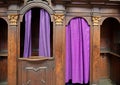 Old-fashioned wooden confessional in Catholic church Royalty Free Stock Photo