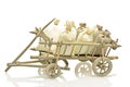 Old fashioned wooden handcart with bags of straw and potatoes