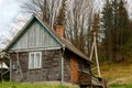 Old-fashioned wooden house on the outskirts of the forest. Among Royalty Free Stock Photo