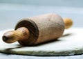 Old-fashioned wooden rolling pin on dough Royalty Free Stock Photo