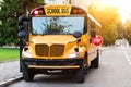 Old-fashioned yellow school bus with red stop sign on the side