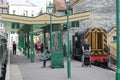 Old fasioned railway station with tourists, guard and train Royalty Free Stock Photo