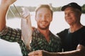 Old Father with Bearded Son Fishing on River. Royalty Free Stock Photo