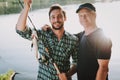 Old Father with Bearded Son Fishing on River. Royalty Free Stock Photo