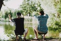 Old Father with Bearded Son Fishing on River. Royalty Free Stock Photo