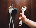 Old faucet and adjustable wrench in hand, plumbing repair concept Royalty Free Stock Photo