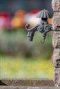 Old faucet at a bricked fountain with blurred background Royalty Free Stock Photo