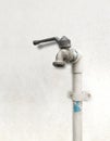 Old and rusted faucet with white PVC pipe Royalty Free Stock Photo