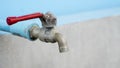 An old faucet with a red handle. Royalty Free Stock Photo