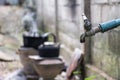 Old faucet with water leaking drop to the ground. Royalty Free Stock Photo