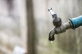 Old faucet with water leaking drop to the ground Royalty Free Stock Photo