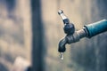 Old faucet with water leaking drop to the ground Royalty Free Stock Photo