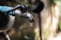 Old faucet with water leaking drop to the ground Royalty Free Stock Photo