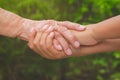 Old female hand holding young boys hands Royalty Free Stock Photo