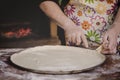 Old female hands shaping the pizza dough Royalty Free Stock Photo