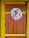 Old female hat with brim on the front door of a village house. Royalty Free Stock Photo