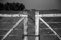 an old fence with a chain link leading to the distance