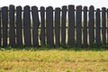Old fence of logs. Palisade against the blue sky Royalty Free Stock Photo