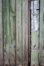Old fence made of wooden planks, in the style of rustic, grunge, worn gray-green color with nails Royalty Free Stock Photo
