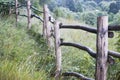 Old fence in the village in the summer grass in the sun Royalty Free Stock Photo