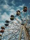 Old ferris wheel over sky background in an abandoned amusement park. Dark scene, ghost and empty carousel with no people for Royalty Free Stock Photo