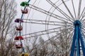 Old ferris wheel in the park in autumn. Indoor amusement park. Attraction for children.