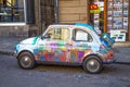 Old Fiat 500 Cinquecento hand painting on the streets of Genoa, Italy.