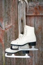 Old figure ice skates on a rustic wooden wall Royalty Free Stock Photo