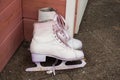 Old figure skates stand on the porch at the entrance to the house Royalty Free Stock Photo