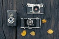 Old film camera on grunge dark wooden background