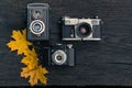 Old film camera on grunge dark wooden background