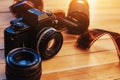 Old film camera and a roll of on wood Royalty Free Stock Photo