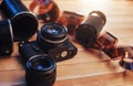 Old film camera and a roll of on wood Royalty Free Stock Photo