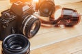 Old film camera and a roll of on wood Royalty Free Stock Photo