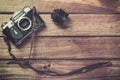 Old film camera with strap and lens on wooden background. Vintage toned and top view with free space Royalty Free Stock Photo