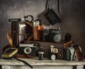 Old film cameras, photographic film, leather cases for photographic equipment. Old photographic equipment. Royalty Free Stock Photo