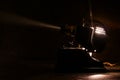 Old film projector, running and projecting with visible beam of light. Royalty Free Stock Photo