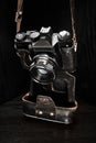 An old film rangefinder SLR camera in a shabby case on a dark background Royalty Free Stock Photo